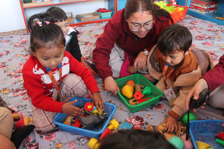 small children are playing with teacher