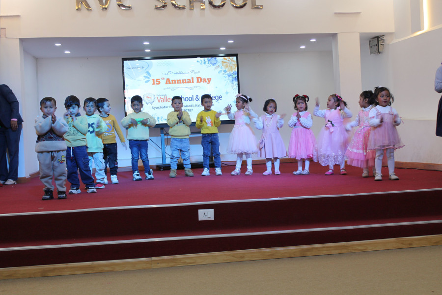 Colorful stage performance by preschool students at 15th Annual Day